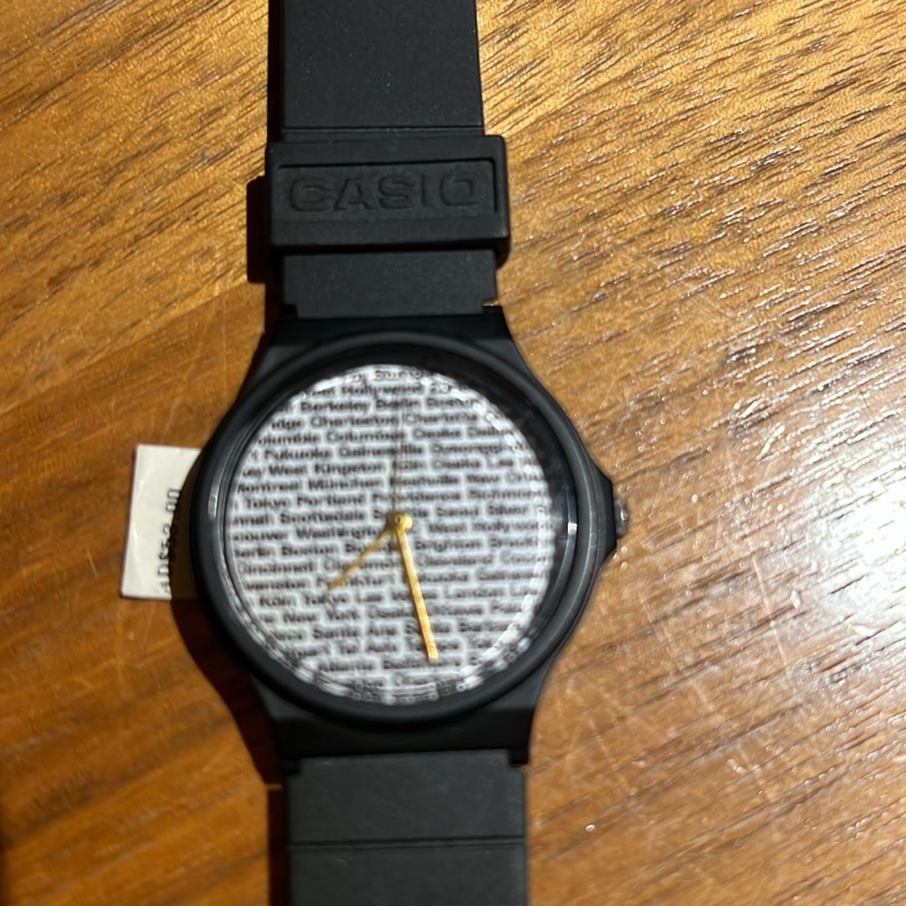 Casio watch large cities print round white face black buckle band